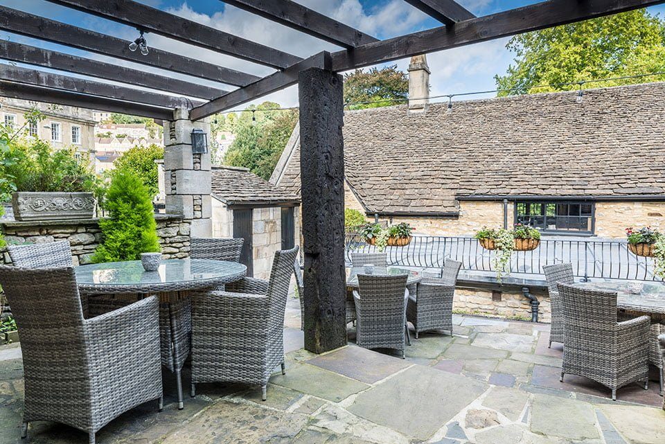 The terrace under oak beams, looking over the rooftops of Bradford on Avon