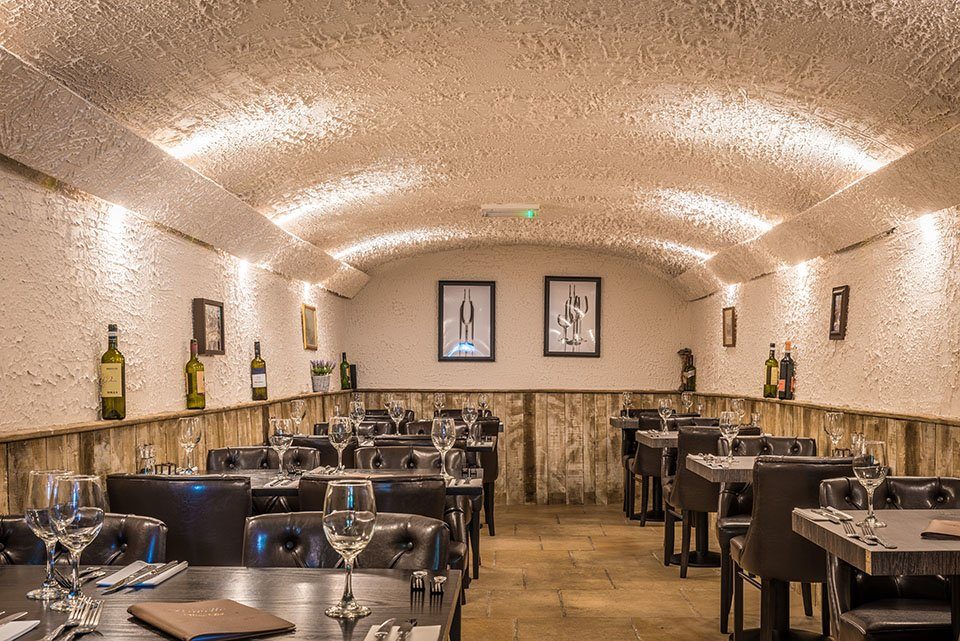 The vaulted dining room, laid for a party